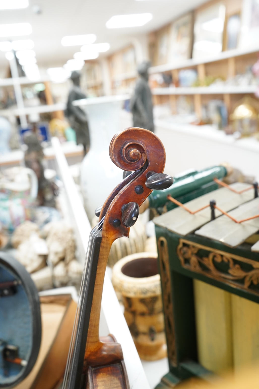 An early 20th century cased violin and cover, 60cm long